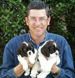 Jim Zim with two chocolate parti puppies